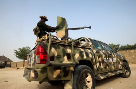 FILE PHOTO: Nigerian military prepare to cordon the area where a man was killed by suspected militants during an attack around Polo area of Maiduguri