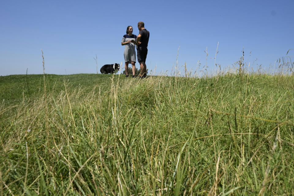 Lara Arias, a rare female golf course superintendent, walks on the course flanked by her assistant Victor Wood Escutia during an interview with the Associated Press, at the Marco Simone Club in Guidonia Montecelio, Italy, Tuesday, July 11, 2023. When Lara Arias started her job as course superintendent at the Marco Simone golf club outside Rome that will host the Ryder Cup from Sept. 29 to Oct.1 there was hardly any grass to manicure, no bunkers to rake and nary a green to shape, the entire course was practically one big pile of dirt amid a complete restyling. (AP Photo/Alessandra Tarantino)