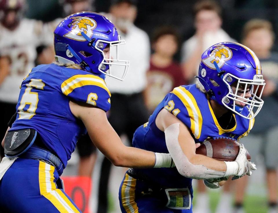 Brock quarterback Tyler Moody (6) hands the ball to running back Kutter Wilson (21) during a high school Class 3A Division 1 Quarterfinals playoff game at Globe Life Field in Arlington, Texas, Thursday, Dec. 02, 2021. Brock led 28-0 at the half. (Special to the Star-Telegram Bob Booth)