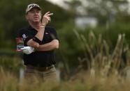 Miguel Angel Jimenez of Spain waits on the third fairway during a practice round ahead of the British Open Championship at the Royal Liverpool Golf Club in Hoylake, northern England July 16, 2014. REUTERS/Toby Melville (BRITAIN - Tags: SPORT GOLF)