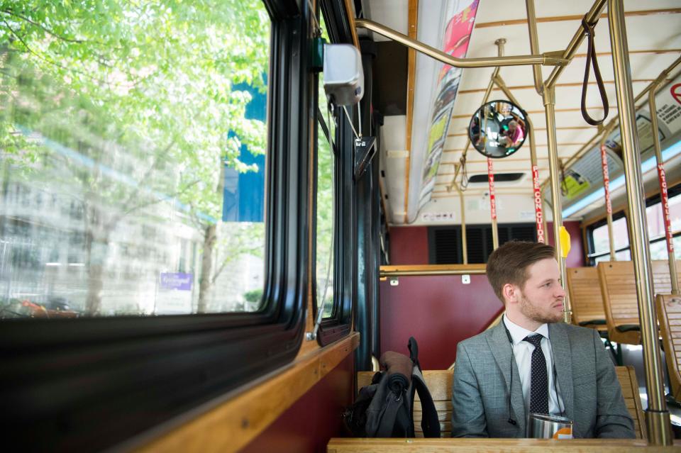 UT Law student Andrew Cox rides the free orange line trolley from the trolley superstop on Main Street in downtown Knoxville on April 17, 2019.