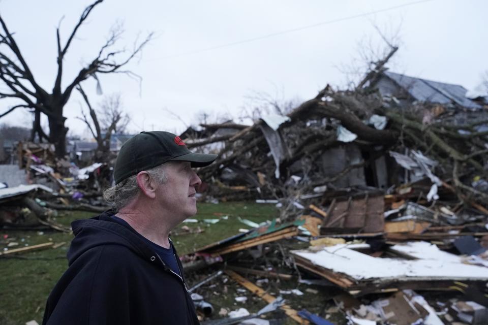 Greg McDougle walks near debris Friday, March 15, 2024, following a severe storm in Lakeview, Ohio. (AP Photo/Joshua A. Bickel)