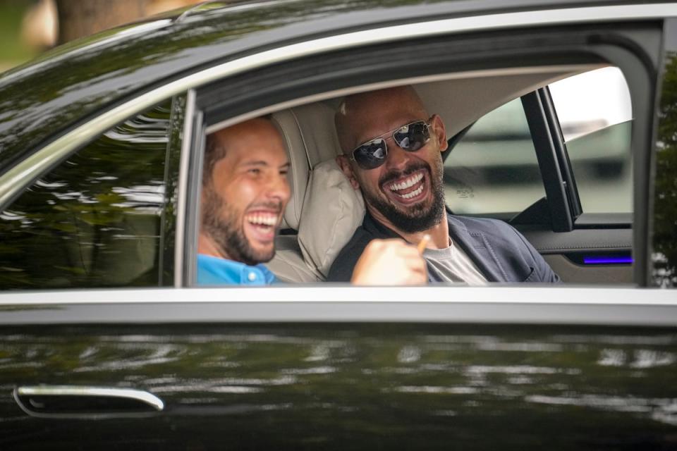 Andrew Tate, right, and his brother Tristan laughed as they left the Tribunal in Bucharest, Romania, in May (Copyright 2024 The Associated Press. All rights reserved.)