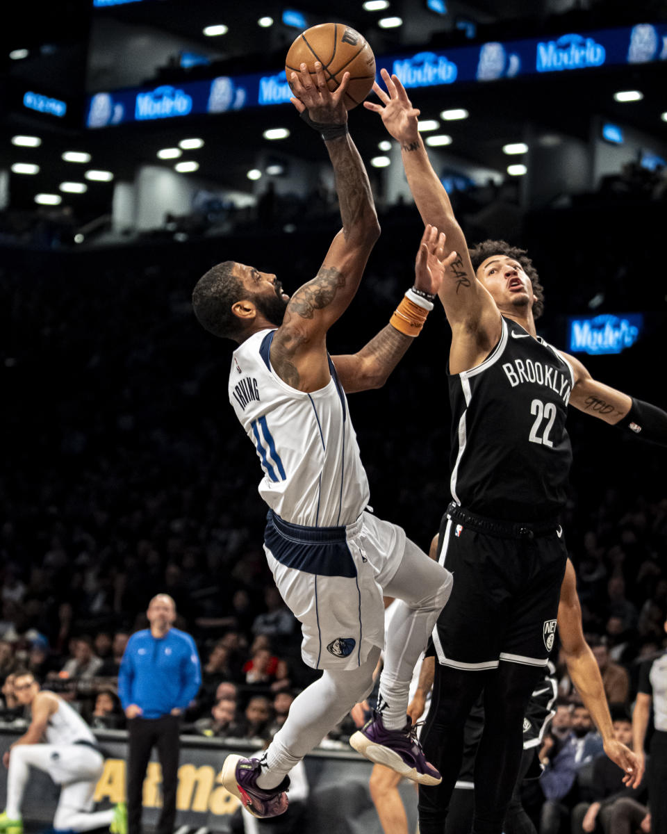 Dallas Mavericks guard Kyrie Irving (11) shoots against Brooklyn Nets forward Jalen Wilson (22) during the first half of an NBA basketball game in New York, Tuesday, Feb. 6, 2024. (AP Photo/Peter K. Afriyie)