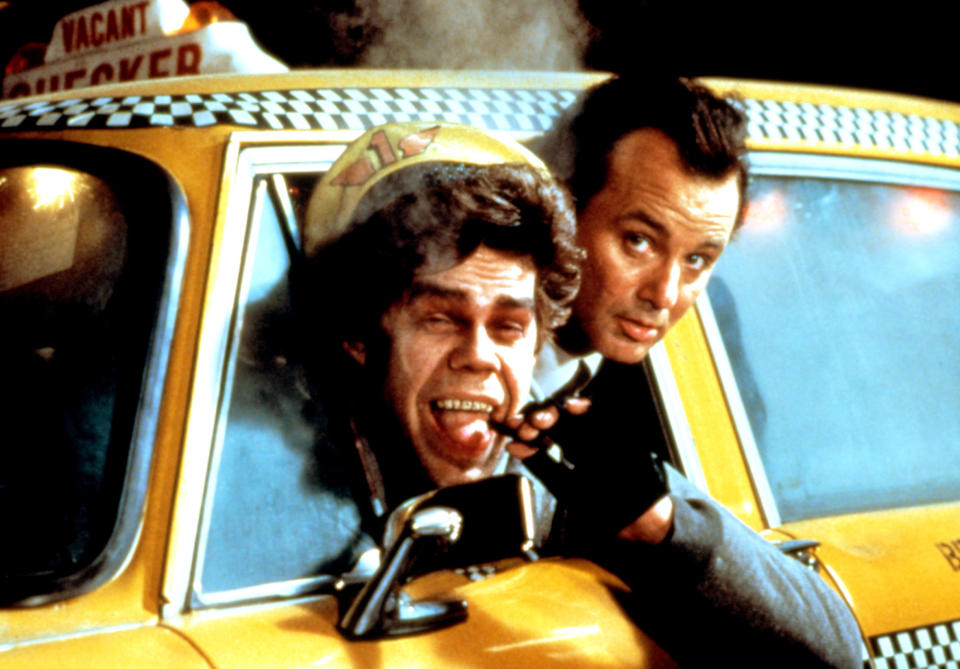 David Johansen and Bill Murray sticking their heads out of a taxi cab.