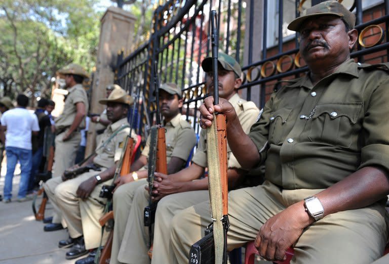 Armed Indian policemen on guard at the main gate of the M. Chinnaswamy Stadium in Bangalore on December 25, 2012. Police were out in full force in Bangalore on Tuesday as part of a massive security operation ahead of Pakistan's first cricket tour of India for five years