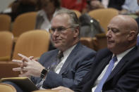 Pacific Gas and Electric Company (PG&E) CEO Bill Johnson, left, waits for a meeting to begin at California Public Utilities Commission headquarters in San Francisco, Friday, Oct. 18, 2019. (AP Photo/Jeff Chiu)