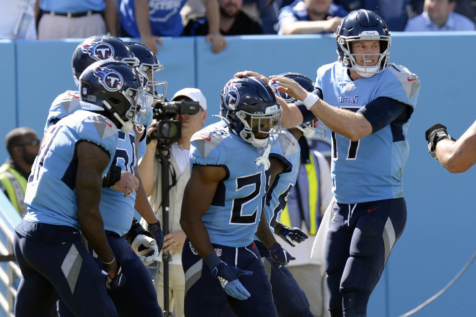 Tennessee Titans running back Jeremy McNichols (28) is congratulated by quarterback Ryan Tannehill (17) after they teamed up for a 10-yard touchdown pass against the Indianapolis Colts in the second half of an NFL football game Sunday, Sept. 26, 2021, in Nashville, Tenn. (AP Photo/Mark Zaleski)