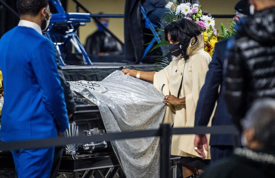 Deanna Brown-Thomas, daughter of the late soul singer James Brown, drapes one of her father's capes over the casket of Danny Ray, the famous emcee and cape man for James Brown, Saturday morning Feb. 13, 2021, at the James Brown Arena in Augusta, Ga. Ray also draped a cape over the casket of James Brown during his funeral in 2006.