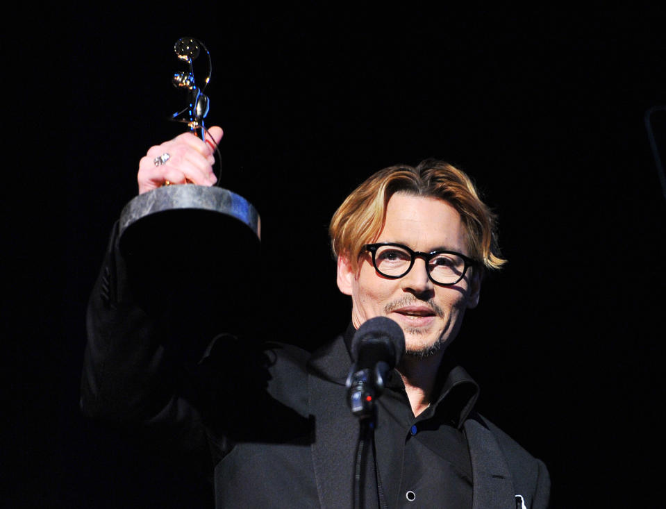 Actor Johnny Depp accepts the Distinguished Artisan Award at The Make-Up Artists and Hair Stylists Guild Awards on Saturday, Feb. 15, 2014 at Paramount Studios in Los Angeles, California. (Photo by Vince Bucci/Invision/AP)