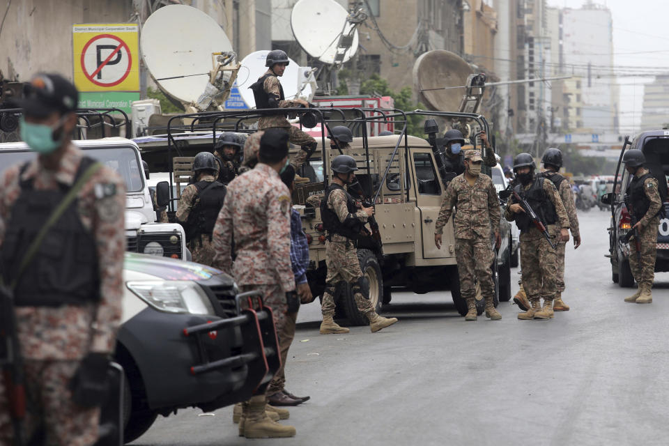 Security personnel surround the Stock Exchange Building after gunmen's attack in Karachi, Pakistan, Monday, June 29, 2020. Special police forces deployed to the scene of the attack and in a swift operation secured the building. (AP Photo/Fareed Khan)