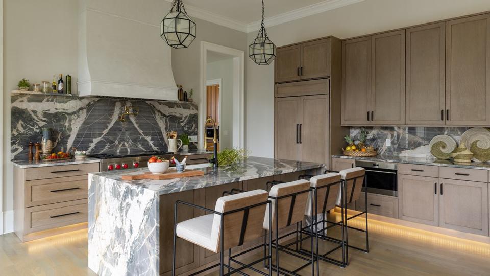 a kitchen with a marble island