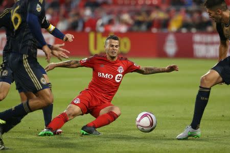 Oct 3, 2015; Toronto, Ontario, CAN; Toronto FC forward Sebastian Giovinco (10) is tripped up agianst the Philadelphia Union at BMO Field. Toronto FC won 3-1. Mandatory Credit: Tom Szczerbowski-USA TODAY Sports