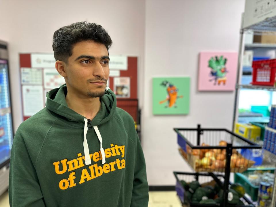 University of Alberta graduate student Zak Kaal volunteers at the Campus Food Bank, and he's also relied on the service as a client for supplementary groceries.