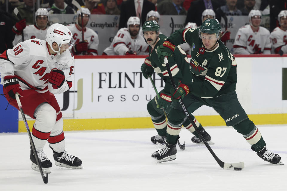 Minnesota Wild left wing Kirill Kaprizov (97) handles the puck against the Carolina Hurricanes during the first period of an NHL hockey game Tuesday, Feb. 27, 2024, in St. Paul, Minn. (AP Photo/Stacy Bengs)