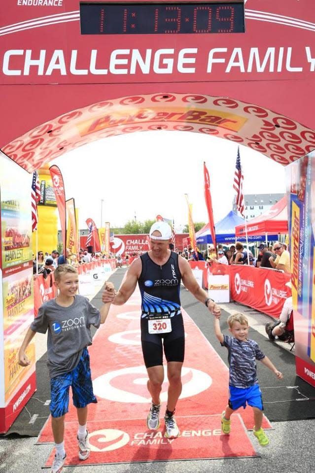 Bobby Rehkemper holds sons hands in past year at a race.