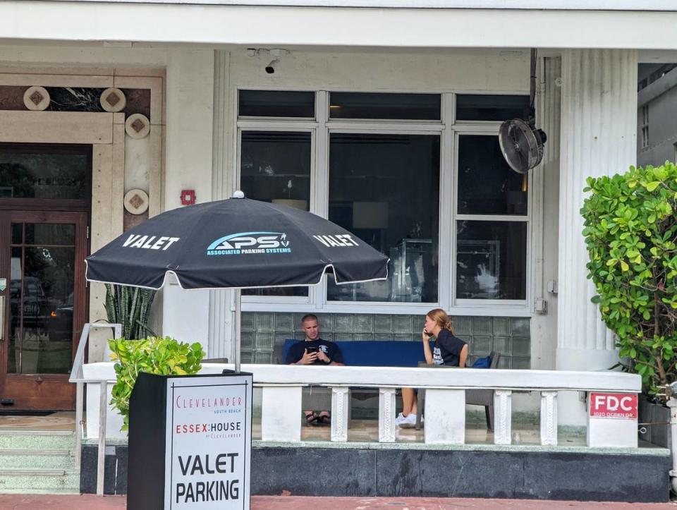 Valet parking attendants sit on a couch in front of the Clevelander Hotel Friday, July 1, 2022. Hours earlier, a hotel employee was shot and killed by a man police say was trying to sneak into the establishment’s nightclub.