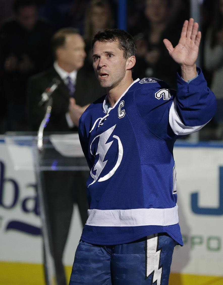 FILE - In this Nov. 25, 2013 file photo, Tampa Bay Lightning right wing Martin St. Louis (26) waves to the fans during a celebration of his 1,000th game before an NHL hockey game against the New York Rangers, in Tampa, Fla. The New York Rangers and Tampa Bay Lightning are pulling off the first major deal on NHL trade deadline day, Wednesday, March 5, 2014, swapping captains Ryan Callahan and Martin St. Louis.(AP Photo/Chris O'Meara, File)