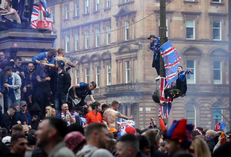 Rangers fans celebrate in George Square, Glasgow, despite the city still being in Scotland’s level 3 of lockdownPA