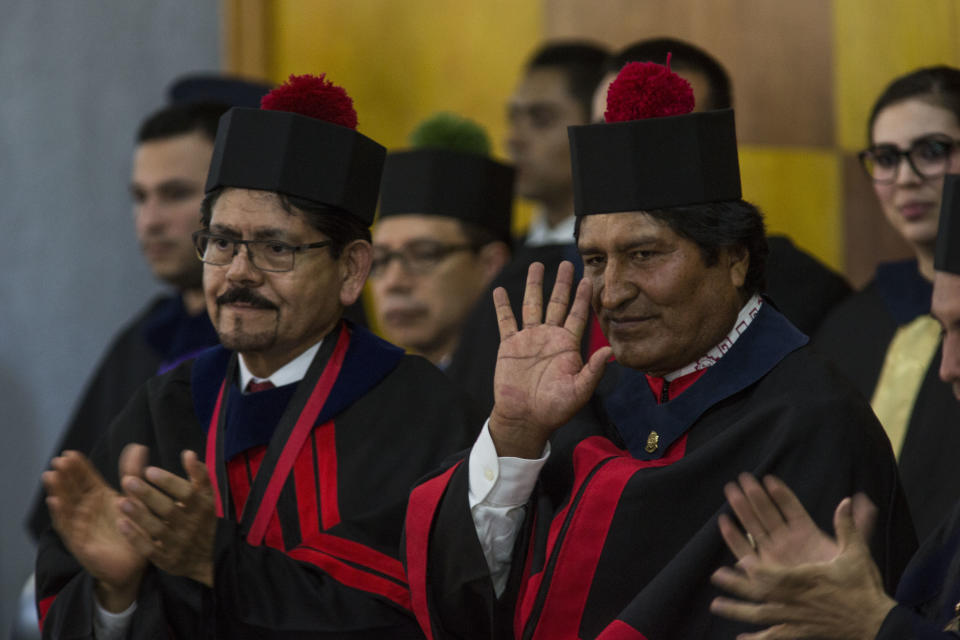 Bolivia's president Evo Morales waves after he was awarded a Honorary Doctorate at the University of Guatemala, Thursday, Nov. 15, 2018. Morales is in Guatemala for the XXVI Iberoamerican Summit that is taking place in Antigua. (AP Photo/Oliver de Ros)