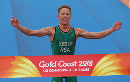 Triathlon - Gold Coast 2018 Commonwealth Games - Men's Final - Southport Broadwater Parklands - Gold Coast, Australia - April 5, 2018 - Henri Schoeman of South Africa crosses the finish line in first place. REUTERS/Athit Perawongmetha