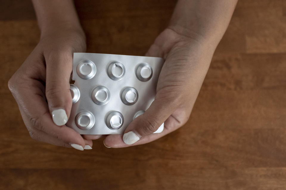 A woman who self-managed her abortion holds a packet of misoprostol. (Josie Norris for NBC News)