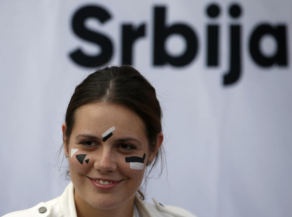 In this photo taken Sept. 25, 2019, a young Serbian rights group activist has her face painted to confuse the Huawei surveillance video cameras with face-recognition software installed in Belgrade, Serbia. With public authorities disclosing little about how the cameras work, the group has set up a tent to ask pedestrians whether they know they are being watched. (AP Photo/Darko Vojinovic)