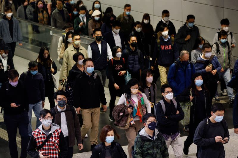 People wear face masks in the MTR station, a day before government scraps the mask rule in Hong Kong