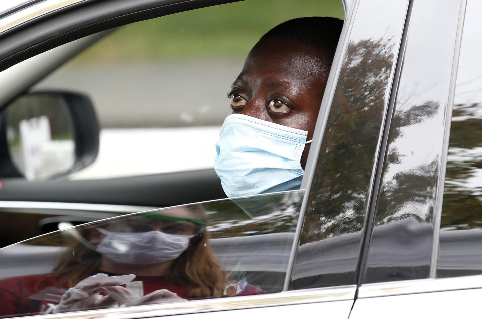 AMHERST, MA - SEPTEMBER 9: Clement Boaheng, 24, a first year Graduate Student in Public Health at UMass Amherst talks with nursing student Claire Sullivan after he gave her his self administered COVID-19 test at a drive through coronavirus testing site on campus in Amherst, MA on Sept. 9, 2020. (Photo by Jessica Rinaldi/The Boston Globe via Getty Images)