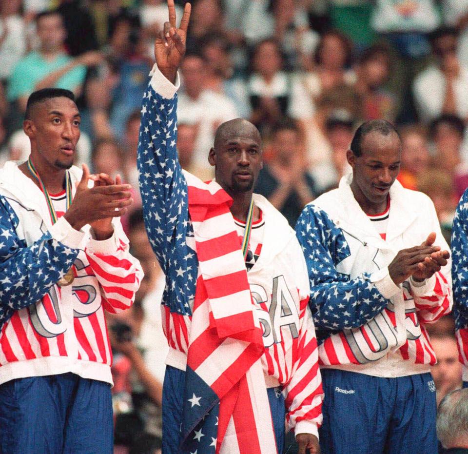 Michael Jordan poses with his gold medal and a flag draped over his shoulder at the Summer Olympics in Barcelona on Aug. 8, 1992.