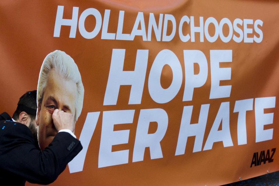 A man poses as crying firebrand anti-Islam lawmaker Geert Wilders during a small demonstration outside parliament in The Hague, Netherlands, Thursday, March 16, 2017. Dutch political parties were preparing Thursday to start what will likely be a long process of coalition talks after Prime Minister Mark Rutte's right-wing VVD easily won national elections, defying polls that suggested a close race with anti-Islam populist Geert Wilders. (AP Photo/Peter Dejong)