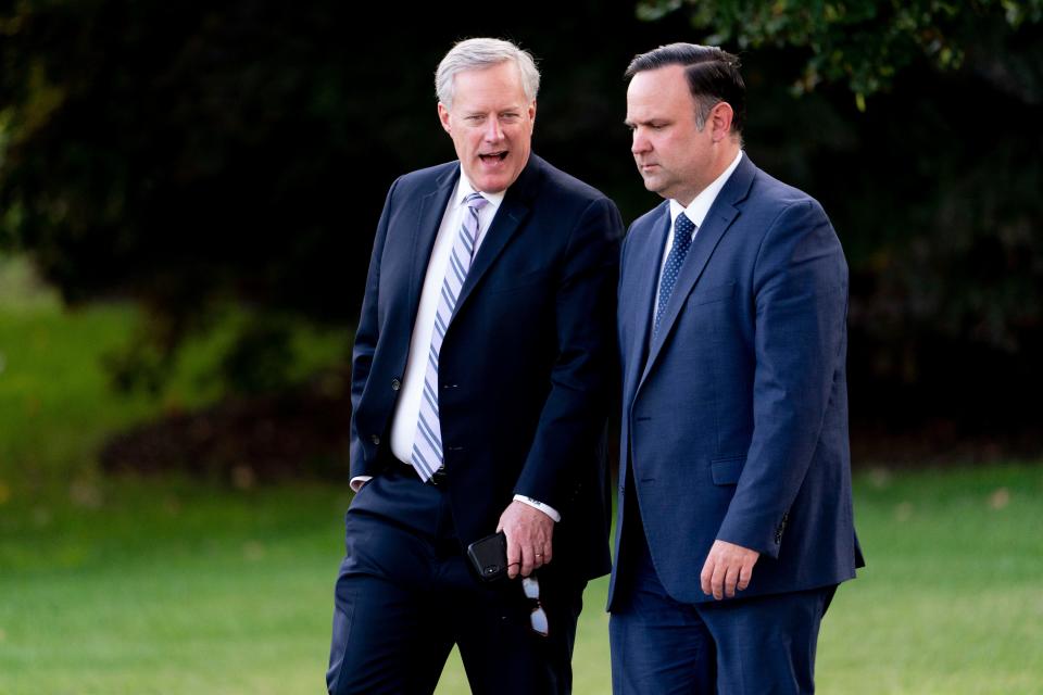 White House official Dan Scavino, right, and White House chief of staff Mark Meadows, left, walk toward Marine One with President Donald Trump on the South Lawn of the White House in Washington on Tuesday, Sept. 22, 2020.