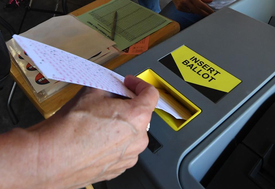 A voter inserts her ballot at a lifeguard headquarters in Hermosa Beach, Calif., during the 2018 midterm elections (Photo: Mark Ralston/AFP/Getty Images)