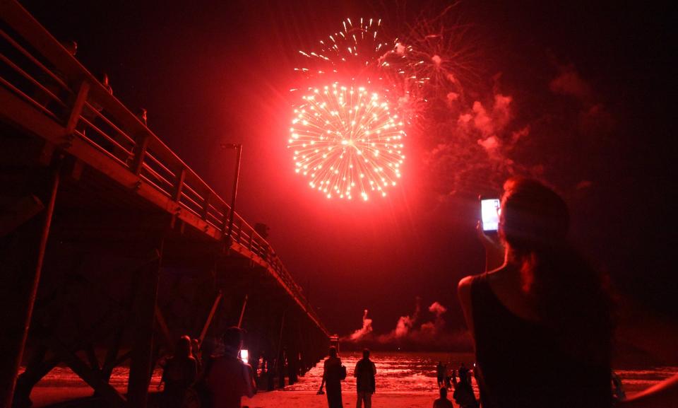 Fireworks light up the sky over the Oak Island Pier in Oak Island.