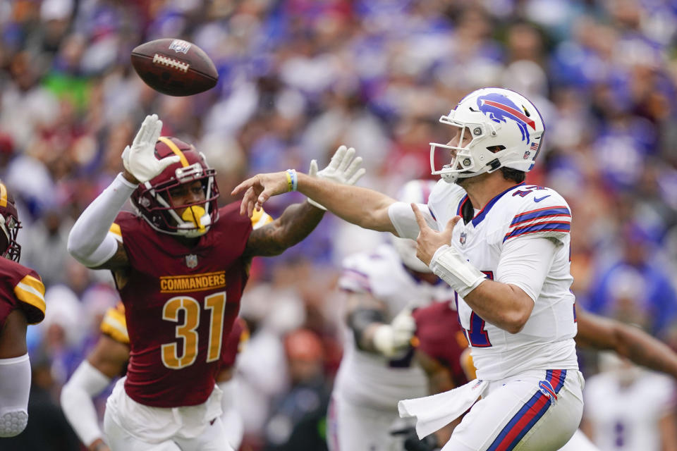 Buffalo Bills quarterback Josh Allen (17) throwing the ball as Washington Commanders safety Kamren Curl (31) rushes in during the first half of an NFL football game, Sunday, Sept. 24, 2023, in Landover, Md. (AP Photo/Evan Vucci)