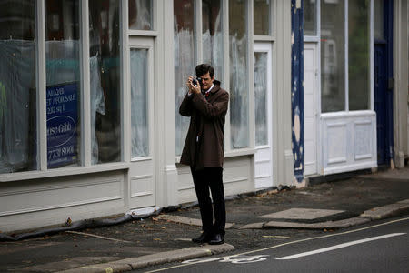 A man photographs a Remembrance Sunday parade through Fulham in West London, Britain November 8, 2015. REUTERS/Kevin Coombs