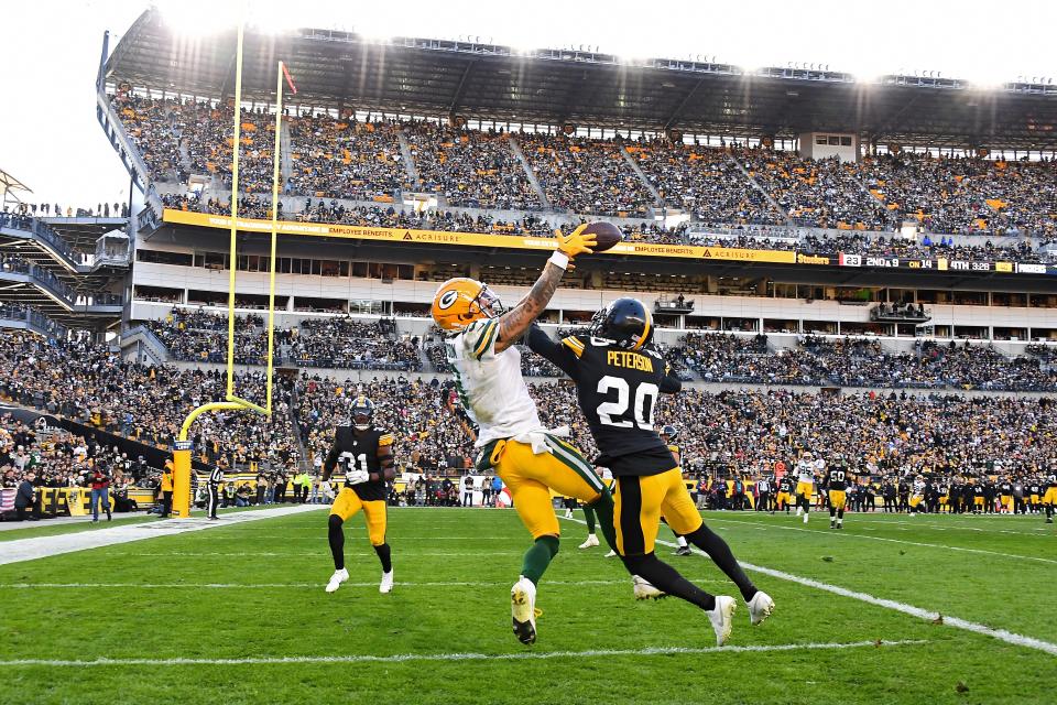 Christian Watson can't catch a pass that was tightly defended by Patrick Peterson of the Pittsburgh Steelers in the fourth quarter last Sunday that ended up being intercepted on a tipped ball.
