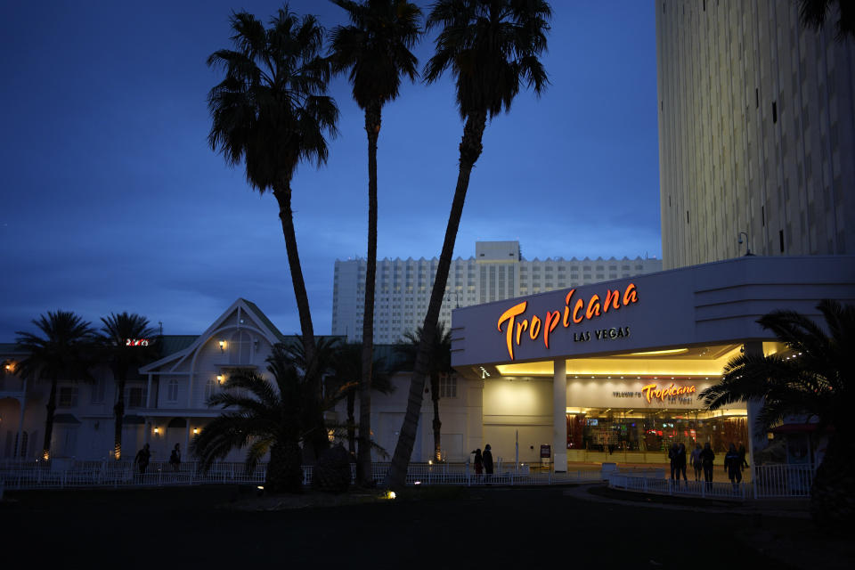 People walk outside of the Tropicana hotel-casino Thursday, March 28, 2024, in Las Vegas. The property is scheduled to close April 2, 2024. (AP Photo/John Locher)