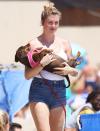 <p>Ireland Baldwin cradles a Dachshund while enjoying the beach in Malibu on Sunday. </p>