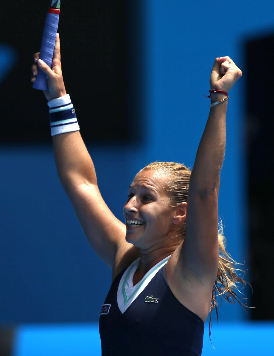 Dominika Cibulkova of Slovakia celebrates her win over Maria Sharapova of Russia during their fourth round match at the Australian Open tennis championship in Melbourne, Australia, Monday, Jan. 20, 2014.(AP Photo/Aaron Favila)