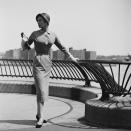 <p>A stylish woman poses on the sidewalks lining Manhattan's East River. </p>