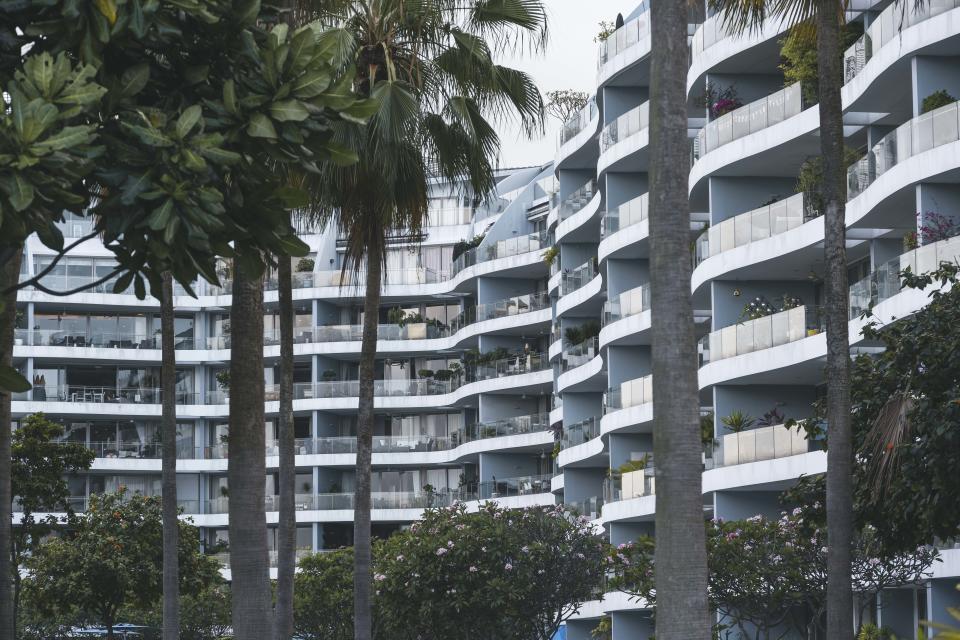 Modern residential area in Singapore. People live in small compact smart home apartments close to the neighbour. This aerial view shows the Sentosa Cove area in the southern tip of Singapore.