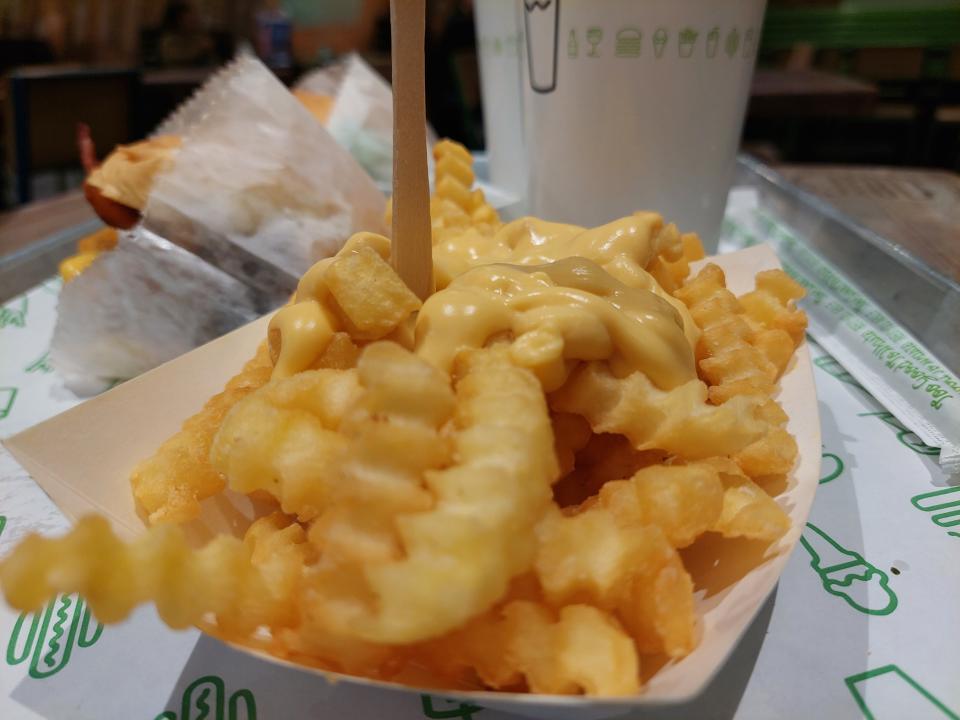 Cheesy fries from Shake Shack, presented on a tray