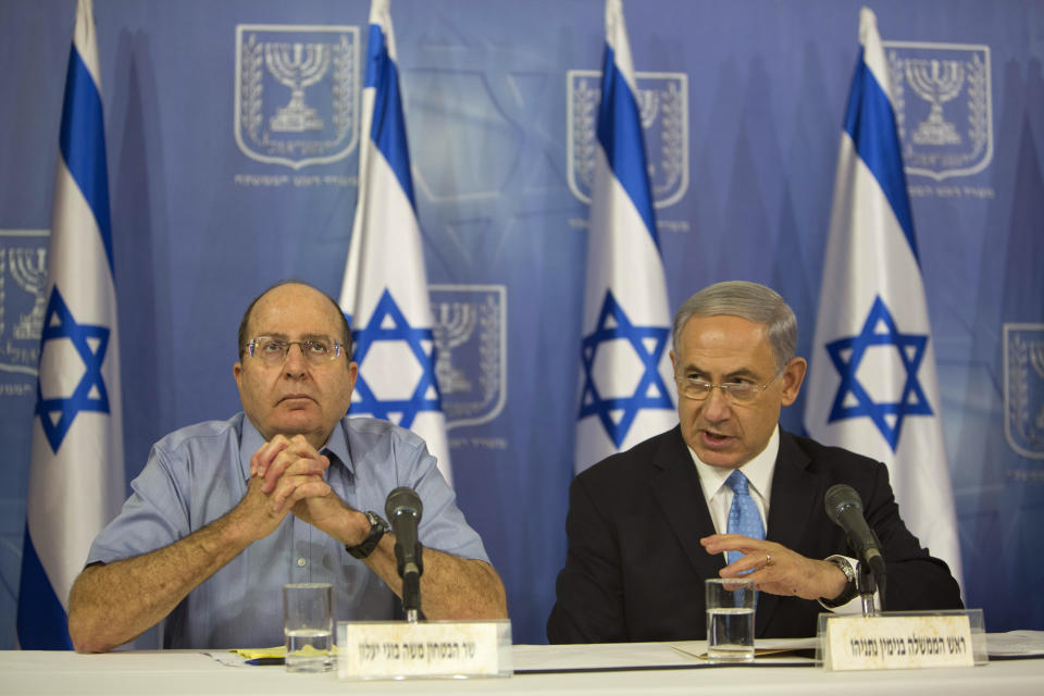 FILE - Israeli Prime Minister Benjamin Netanyahu, right, and Israeli Defense Minister Moshe Ya'alon speak to the media during a press conference at the defense ministry in Tel Aviv, Israel, Saturday, Aug. 2, 2014. They contended with bloody uprisings, destabilizing wars and even the assassination of a prime minister during their service. But for dozens of former Israeli security commanders, the policies of Netanyahu’s far-right government are the biggest threat yet to the country’s future. (AP Photo/Oded Balilty, File)
