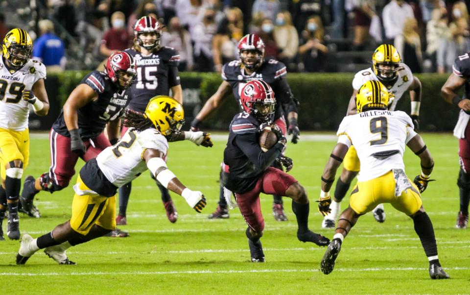 Nov 21, 2020; Columbia, South Carolina, USA; South Carolina Gamecocks wide receiver Shi Smith (13) runs the ball against Missouri Tigers defensive back Ennis Rakestraw Jr. (2) and safety Tyree Gillespie (9) in the first quarter at Williams-Brice Stadium. Mandatory Credit: Jeff Blake-USA TODAY Sports