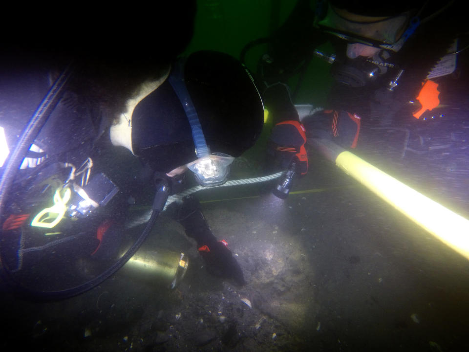A supplied undated image obtained Thursday, February 3, 2022 shows divers at a site in Newport Harbor, Rhode Island,