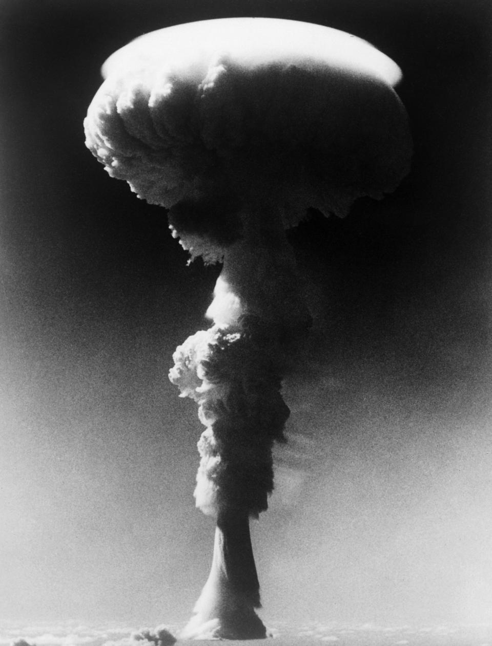 The mushroom cloud generated during Britain's first tests of Operation Grapple, as seen from an aircraft flying above the local natural cloud on May 15 1957; Bass was present at Grapple Y the following year