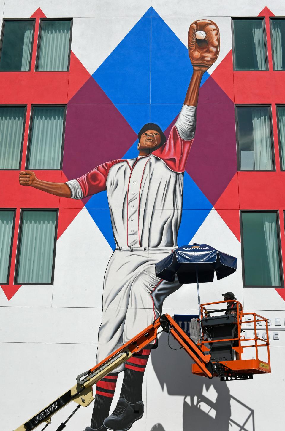 Sarasota artist Matt McAllister works on a 45-foot-by-50-foot mural of former Sarasotan and Negro American League player and manager John Jordan "Buck" O'Neil. The mural will be officially unveiled July 24, the day O'Neil earns induction into the National Baseball Hall of Fame and Museum.