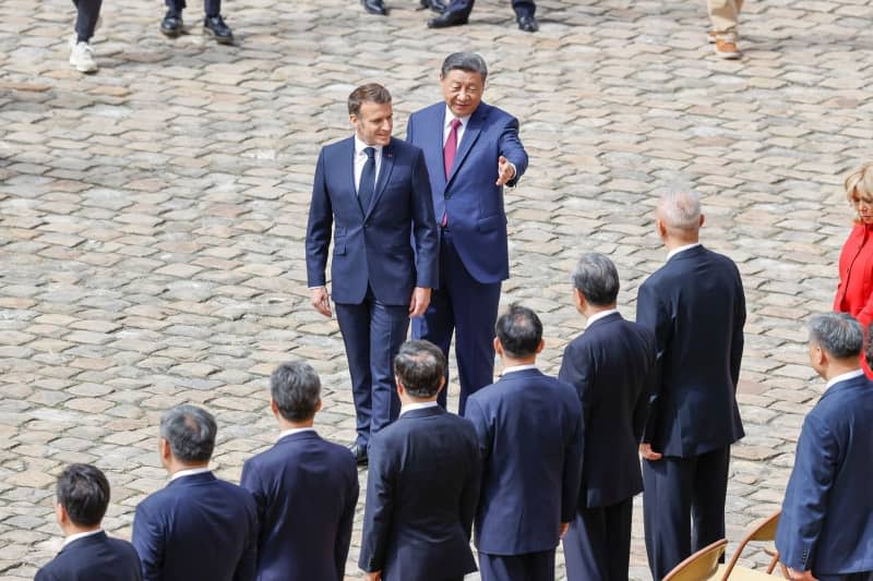 French President Emmanuel Macron and Chinese President Xi Jinping attend an official welcoming ceremony, at the hotel des Invalides. Loic Baratoux/ZUMA Press Wire/dpa