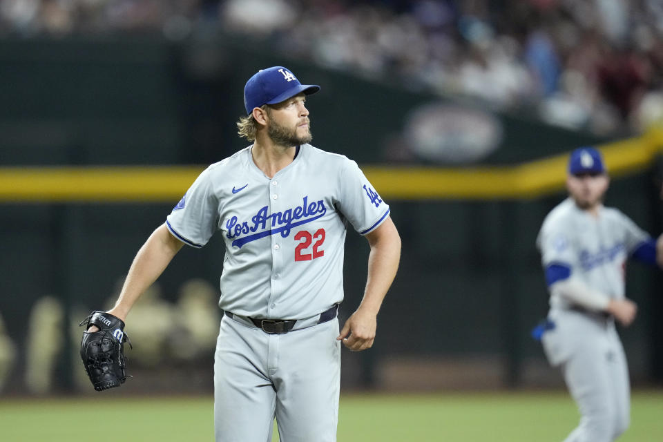 Los Angeles Dodgers pitcher Clayton Kershaw watches the flight of a fly ball during the first inning of a baseball game against the Arizona Diamondbacks Friday, Aug. 30, 2024, in Phoenix. (AP Photo/Ross D. Franklin)